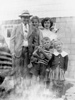 Garland Sr., Nancy, Martha (with Gum Drop), Garland Jr. (with Kitten Candy), and cousin Corliss Poe in front of the Cooper Street home.