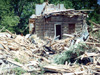 The original Vermillion log cabin amidst the debris of the enveloping frame house.